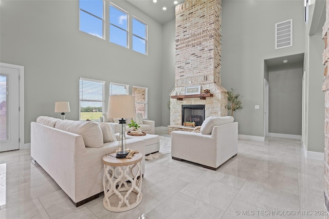 684 Chateau Bnd, Ardmore, OK 73401 - living area with a fireplace, a high ceiling, and light marble finish flooring