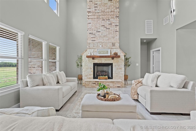684 Chateau Bnd, Ardmore, OK 73401 - living area with a towering ceiling, a fireplace, and wood finished floors