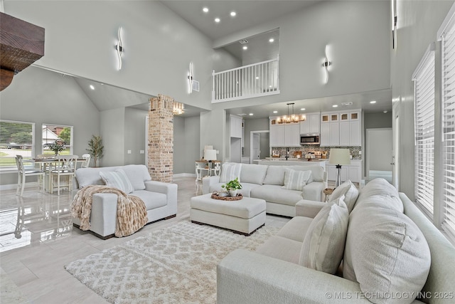 684 Chateau Bnd, Ardmore, OK 73401 - living room with high vaulted ceiling, decorative columns, recessed lighting, and a chandelier