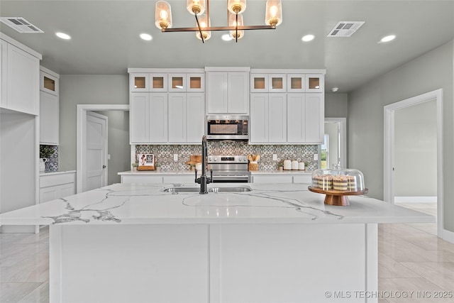 684 Chateau Bnd, Ardmore, OK 73401 - kitchen with appliances with stainless steel finishes, recessed lighting, decorative backsplash, and white cabinetry