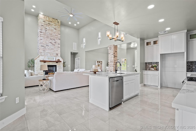 684 Chateau Bnd, Ardmore, OK 73401 - kitchen featuring stainless steel dishwasher, light marble finish flooring, a ceiling fan, open floor plan, and a high ceiling