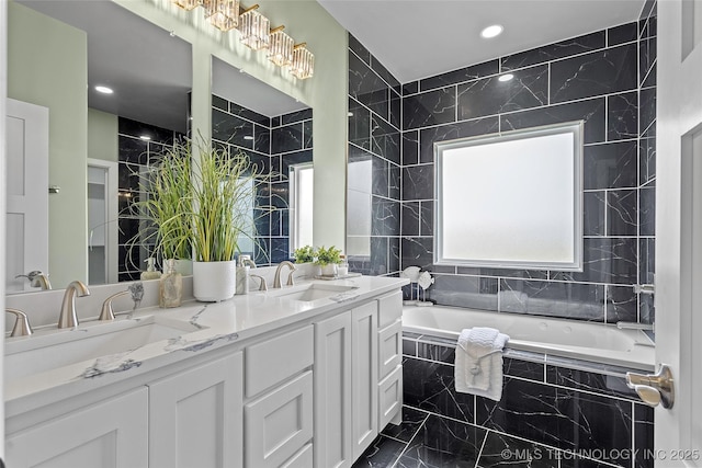 684 Chateau Bnd, Ardmore, OK 73401 - full bath with marble finish flooring, tiled tub, double vanity, tile walls, and recessed lighting