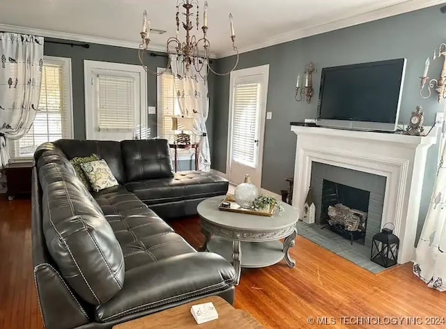 living room featuring wood-type flooring, ornamental molding, and a healthy amount of sunlight