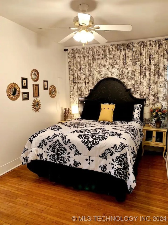 bedroom featuring hardwood / wood-style flooring and ceiling fan