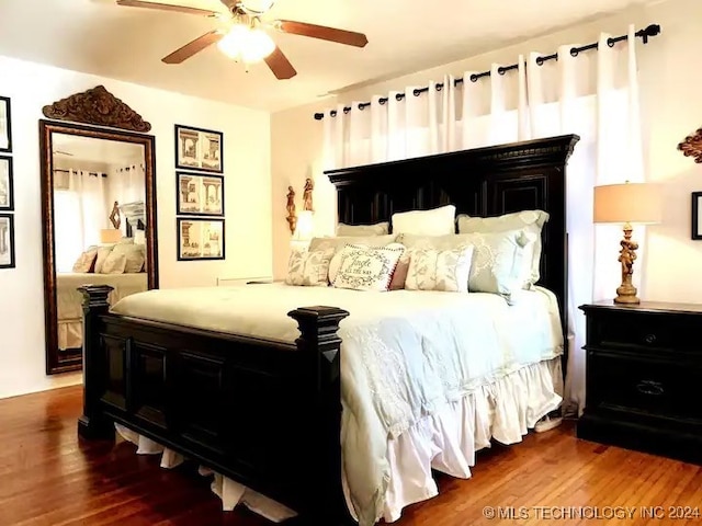 bedroom with hardwood / wood-style floors and ceiling fan