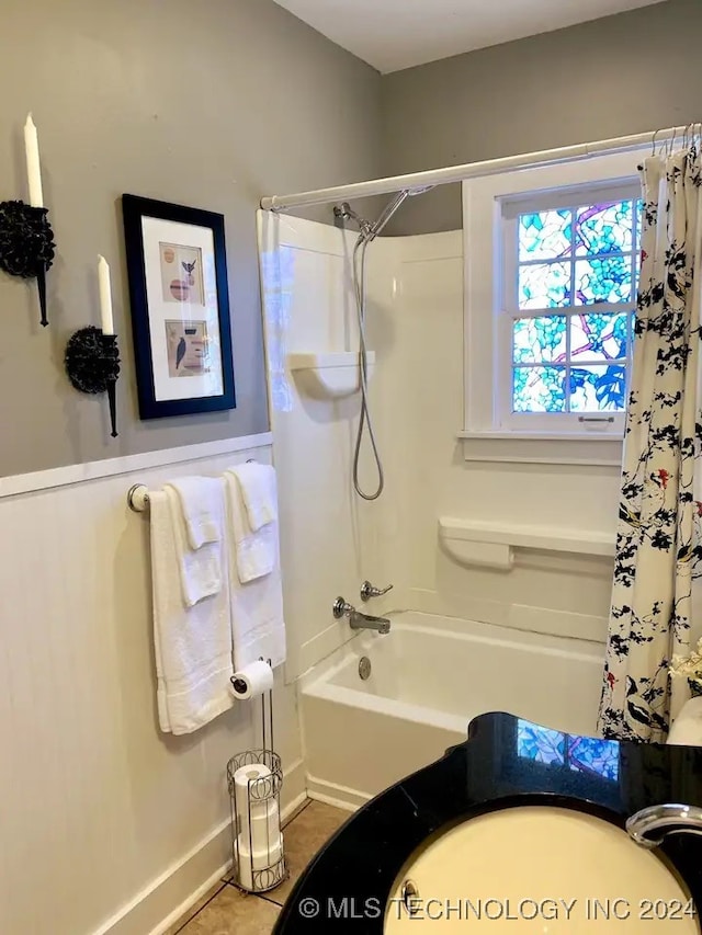 bathroom featuring tile patterned flooring and shower / bath combo with shower curtain