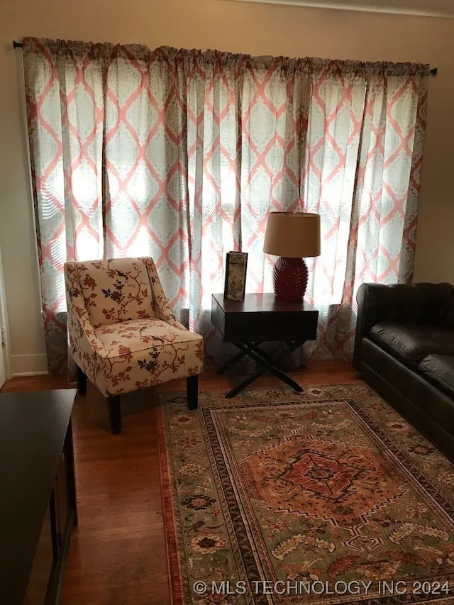 sitting room with hardwood / wood-style floors