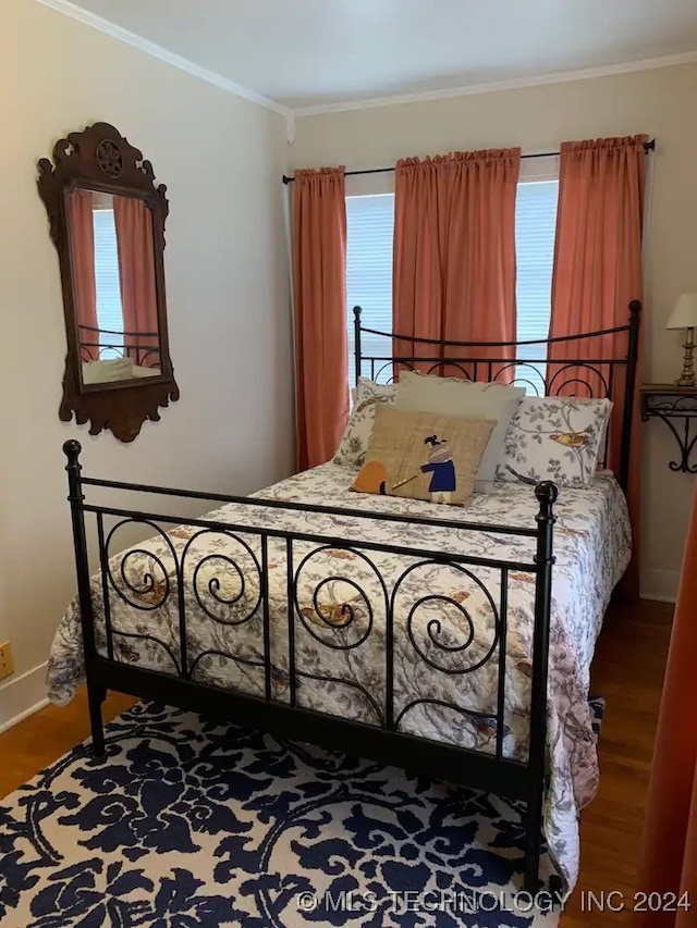 bedroom featuring hardwood / wood-style floors and ornamental molding