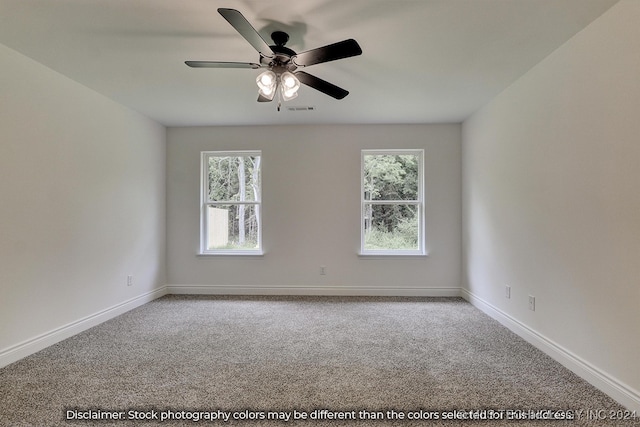 spare room with ceiling fan, a healthy amount of sunlight, and carpet floors