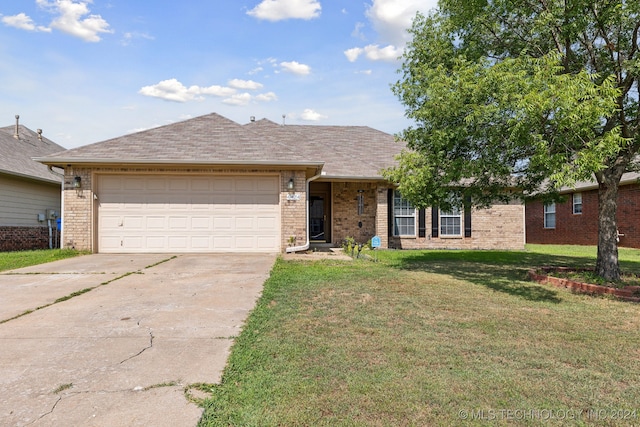 single story home with a garage and a front lawn