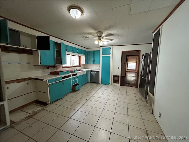 kitchen with blue cabinetry, ceiling fan, sink, stainless steel appliances, and light tile patterned floors