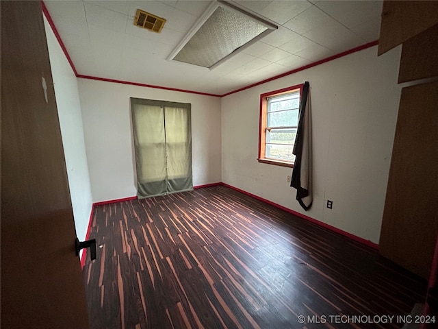 unfurnished room featuring hardwood / wood-style floors and ornamental molding