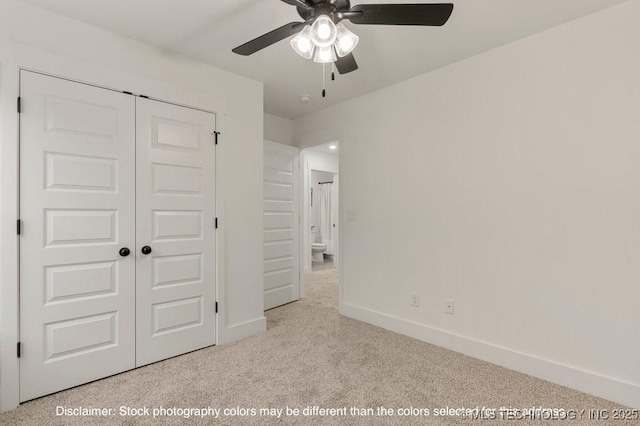 unfurnished bedroom with baseboards, ceiling fan, a closet, and light colored carpet