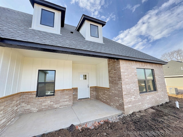 rear view of property with a patio and central AC