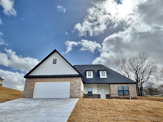 modern inspired farmhouse with a shingled roof, concrete driveway, brick siding, and an attached garage