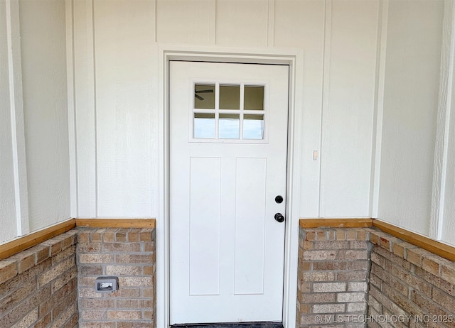 doorway to property with brick siding