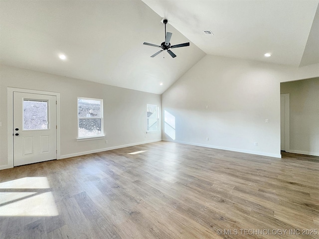 unfurnished room featuring plenty of natural light, ceiling fan, and wood finished floors