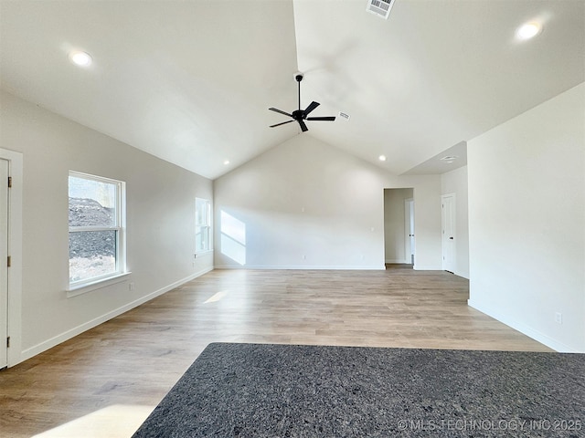 unfurnished living room with baseboards, wood finished floors, visible vents, and a ceiling fan