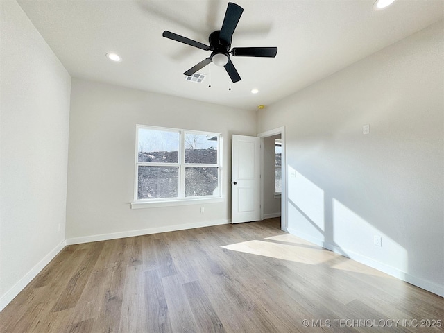 unfurnished room featuring visible vents, baseboards, wood finished floors, and recessed lighting