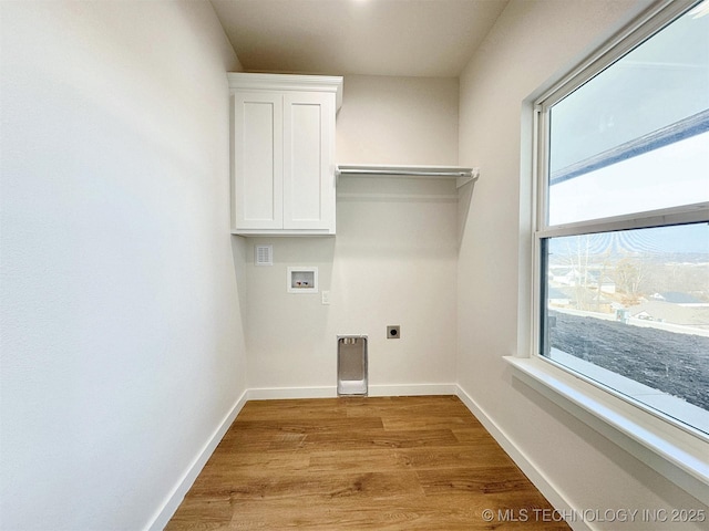 890 E Harlan Dr, Tahlequah, OK 74464 - laundry area with washer hookup, baseboards, light wood-style floors, electric dryer hookup, and cabinet space