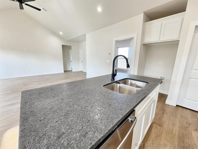890 E Harlan Dr, Tahlequah, OK 74464 - kitchen with dishwasher, ceiling fan, dark stone countertops, white cabinetry, and a sink