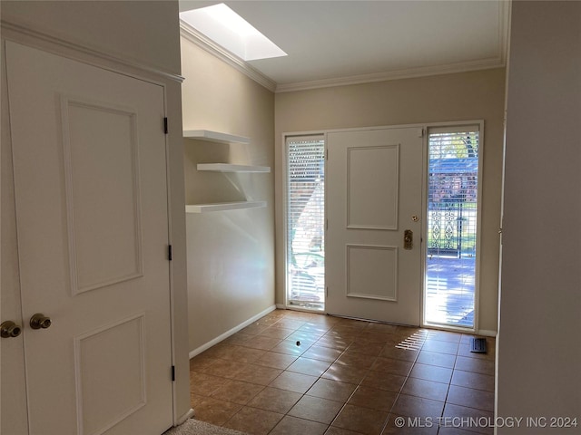 tiled entryway with crown molding and a wealth of natural light