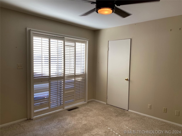 unfurnished room with ceiling fan and light colored carpet