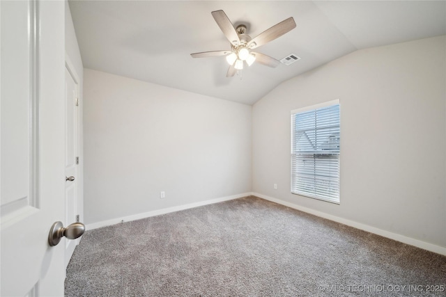 carpeted spare room featuring ceiling fan and vaulted ceiling