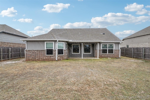 rear view of house featuring a lawn and a patio area