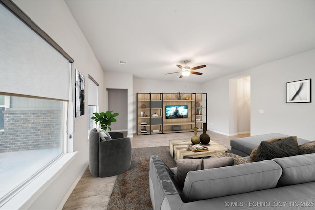 living room with light hardwood / wood-style flooring and ceiling fan