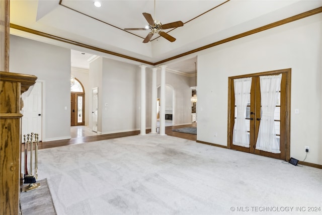 empty room featuring decorative columns, light hardwood / wood-style flooring, ceiling fan, and crown molding