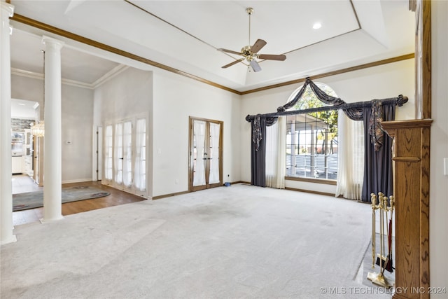 empty room featuring french doors, hardwood / wood-style flooring, ornate columns, and crown molding