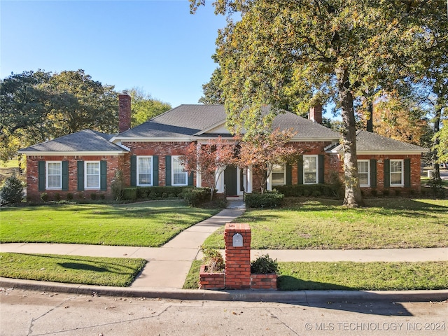 ranch-style home featuring a front yard