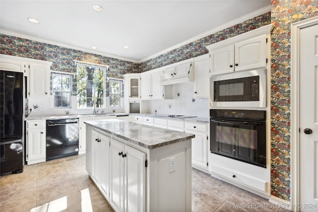 kitchen featuring a center island, black appliances, white cabinets, sink, and crown molding