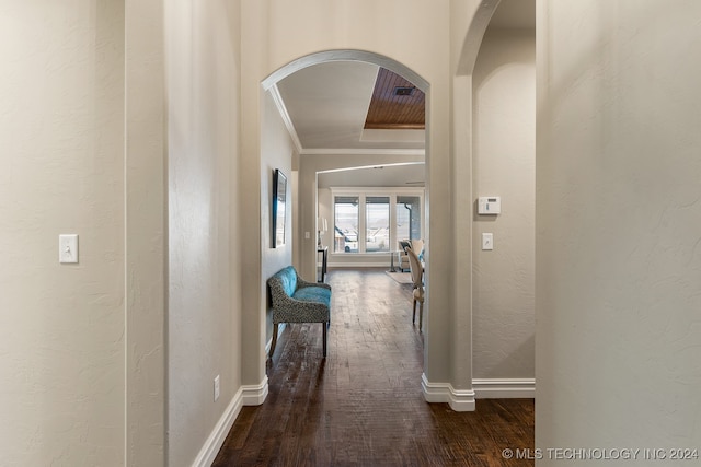 hallway with crown molding and hardwood / wood-style floors