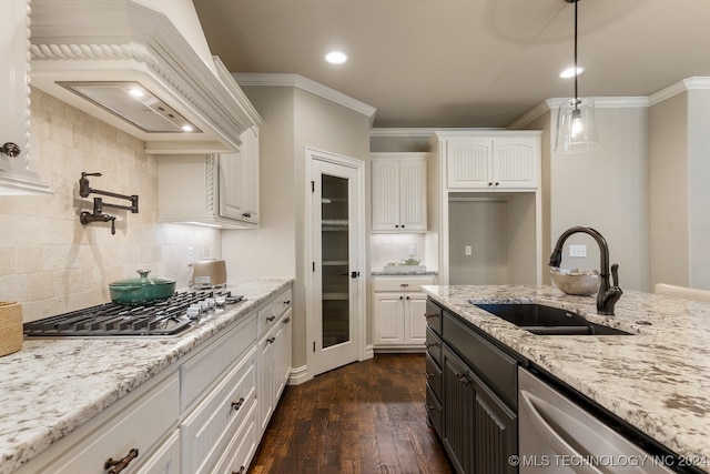 kitchen with backsplash, white cabinets, sink, dark hardwood / wood-style flooring, and stainless steel appliances