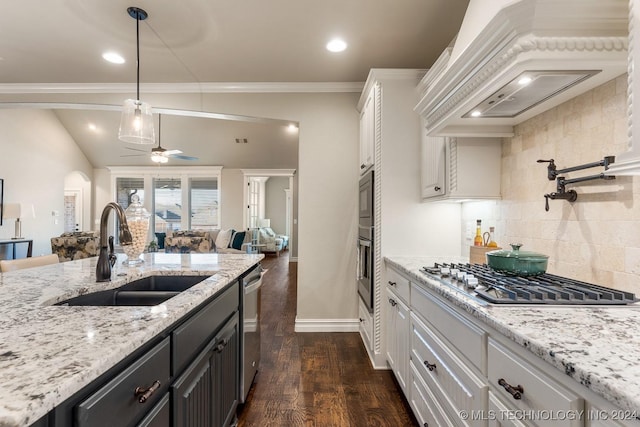 7916 N 145th E Ct, Owasso, OK 74055 - kitchen featuring stainless steel appliances, custom range hood, open floor plan, white cabinets, and ceiling fan