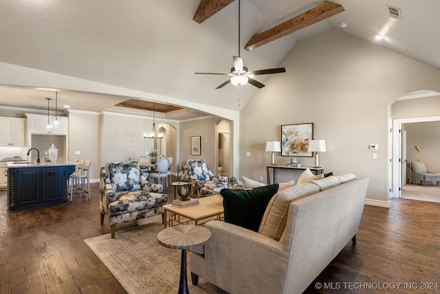 7916 N 145th E Ct, Owasso, OK 74055 - living area with arched walkways, dark wood-type flooring, high vaulted ceiling, a ceiling fan, and a chandelier