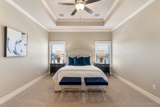 bedroom featuring a raised ceiling, multiple windows, ceiling fan, and carpet floors