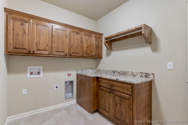 clothes washing area featuring cabinets, washer hookup, and hookup for an electric dryer