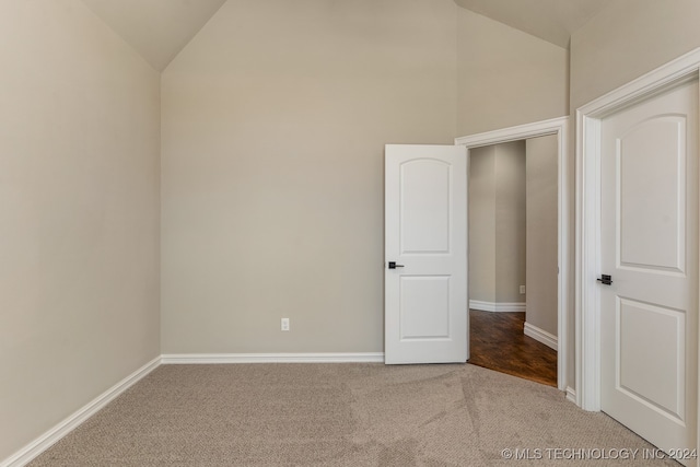 spare room with lofted ceiling and carpet floors