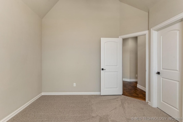 7916 N 145th E Ct, Owasso, OK 74055 - unfurnished bedroom with lofted ceiling and carpet floors