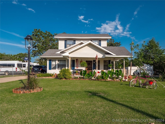 view of front of property featuring a front lawn and covered porch