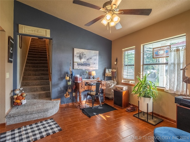 office space featuring hardwood / wood-style floors, ceiling fan, lofted ceiling, and a textured ceiling