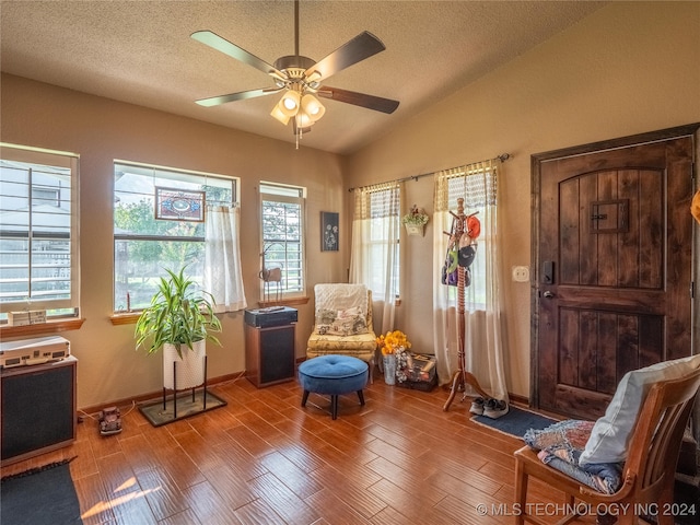 sitting room with a textured ceiling, ceiling fan, vaulted ceiling, and hardwood / wood-style flooring