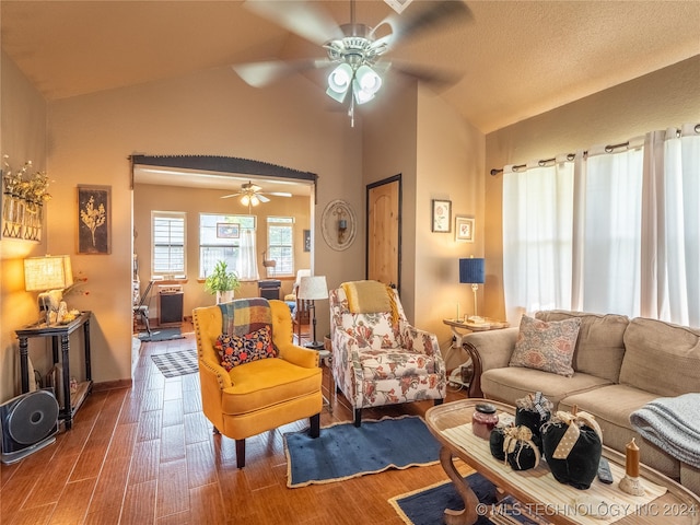 living room featuring hardwood / wood-style floors, a textured ceiling, ceiling fan, and lofted ceiling