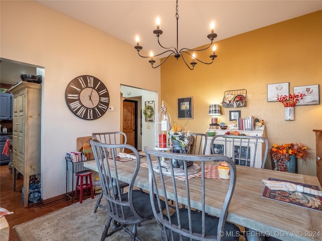 dining area featuring dark hardwood / wood-style flooring and an inviting chandelier