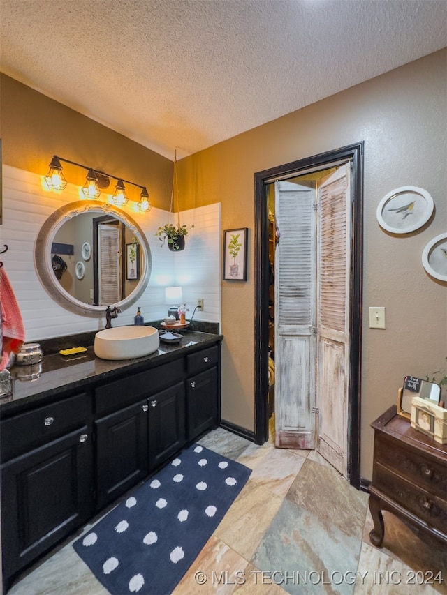 bathroom featuring vanity and a textured ceiling