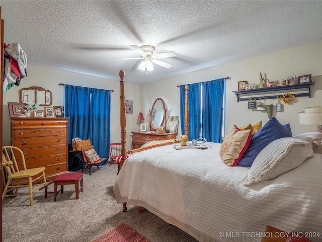 bedroom with carpet flooring, ceiling fan, and a textured ceiling