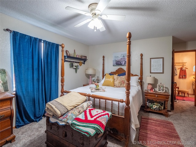 bedroom featuring ceiling fan, carpet floors, and a textured ceiling